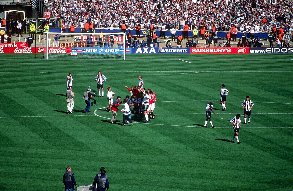 Manchester United players celebrating with the FA Cup at Wembley