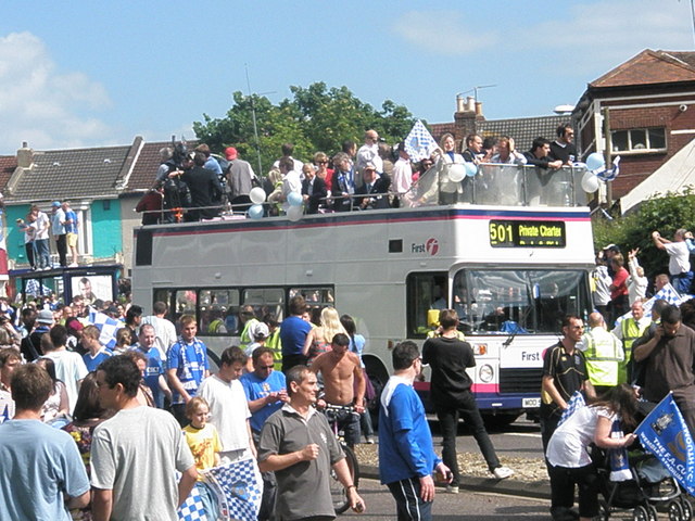 Crowds of Portsmouth supporters celebrating as the victory parade begins
