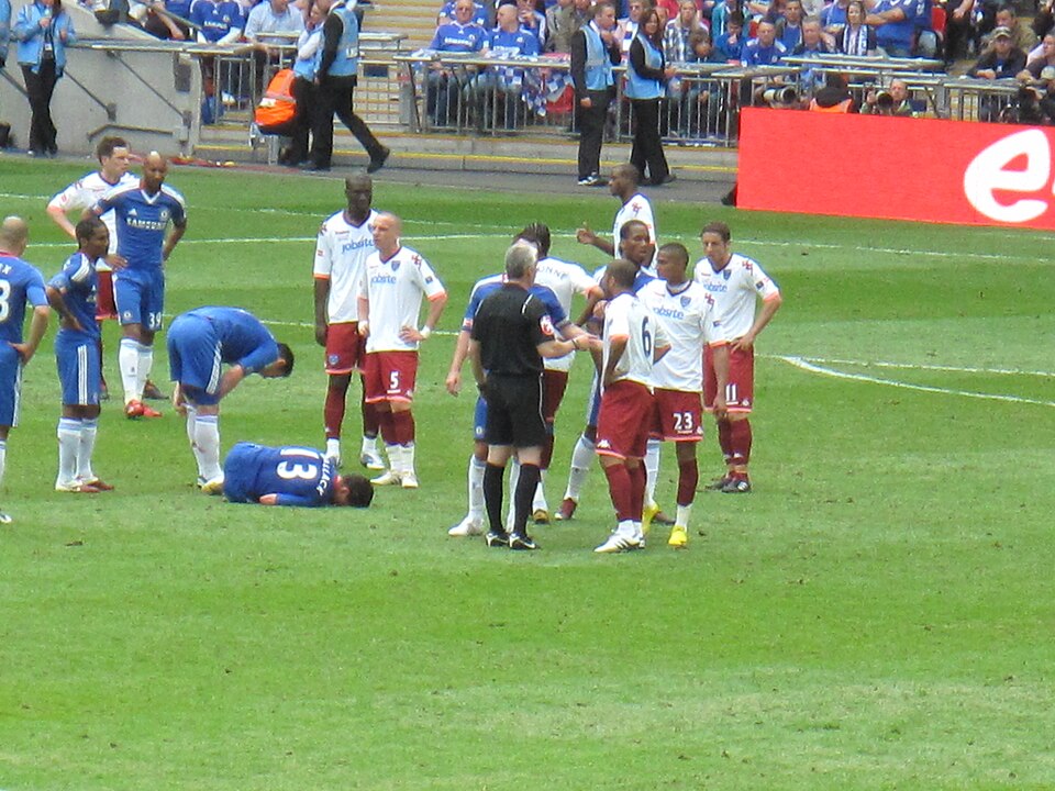 Michael Ballack lying on the pitch in pain after the challenge that injured his ankle