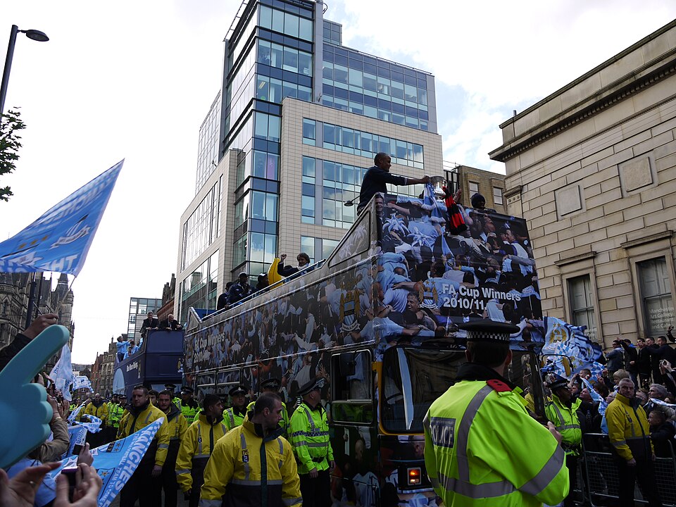 Manchester City players with the trophy on the victory parade