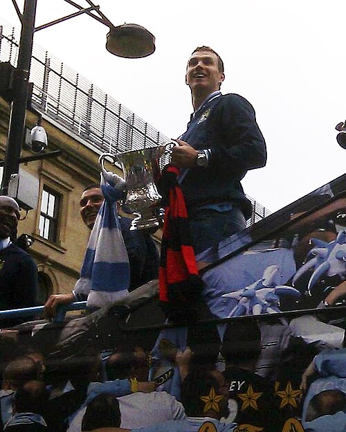 Edin Dzeko holding the FA Cup during the victory parade