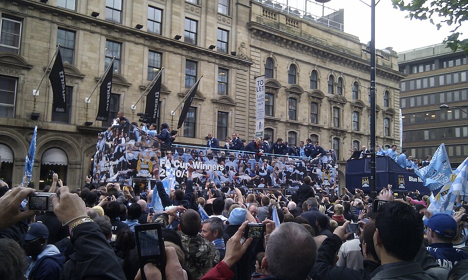Manchester City's open-top bus parade through crowded Manchester streets