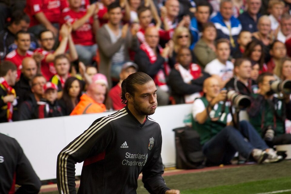 Andy Carroll warming up in a Liverpool training top