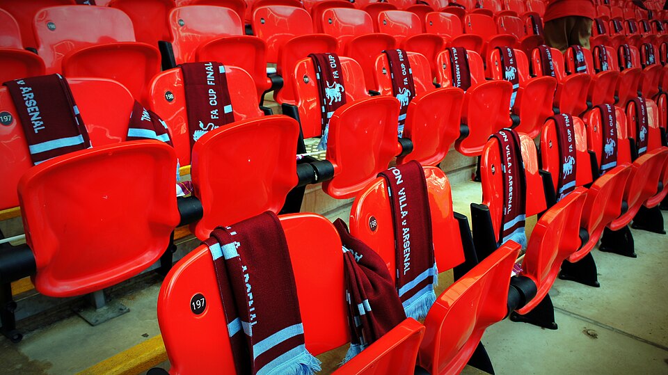 Claret and blue Aston Villa scarves laid out across rows of red Wembley seats