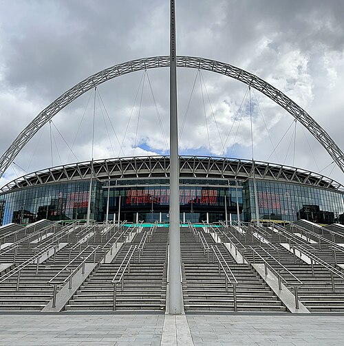 Wembley Stadium seen head on with its arch above the roof